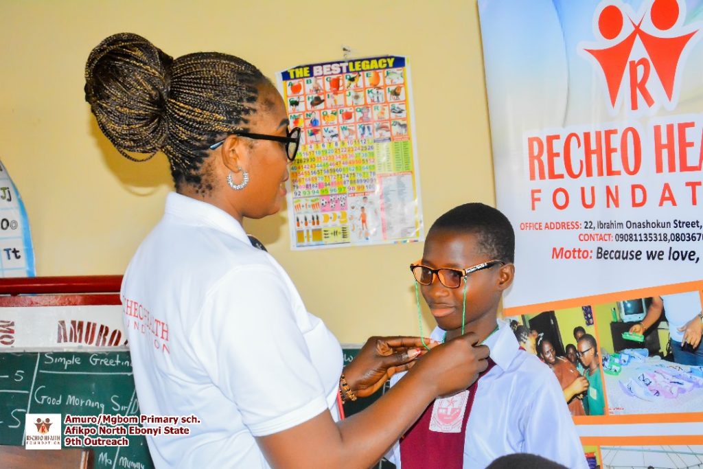 Our beloved Chairperson setting the glasses of one of the beneficiaries.