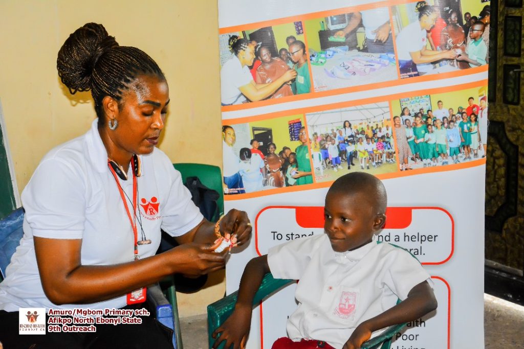 One of the pupils in a smile of hope while our Chairperson was getting ready to attend to him.